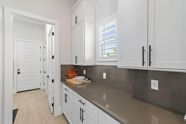 20049 SE Bridgewater Dr, Jupiter, FL 33458 - kitchen featuring dark countertops and white cabinetry