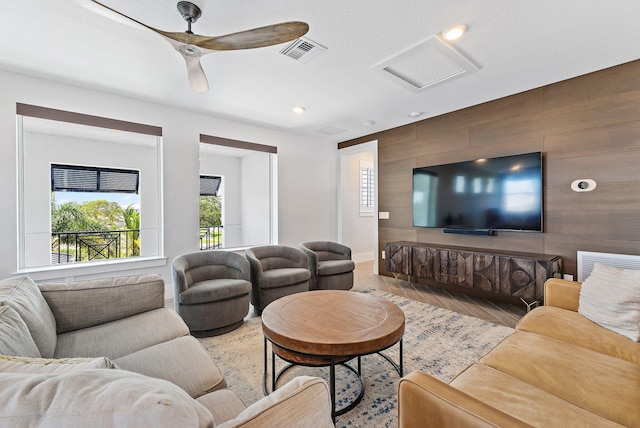 20049 SE Bridgewater Dr, Jupiter, FL 33458 - living room featuring plenty of natural light, light wood-type flooring, attic access, wooden walls, and an accent wall