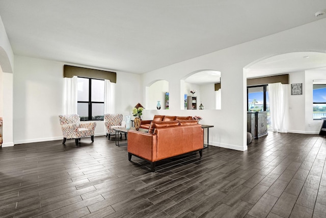living room featuring dark wood-style floors and baseboards