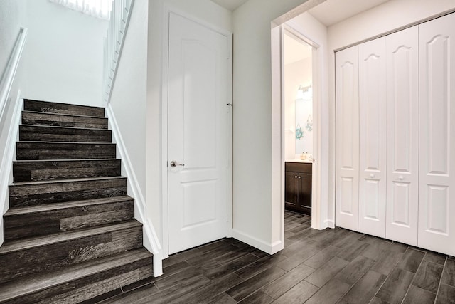stairs featuring wood tiled floors and baseboards