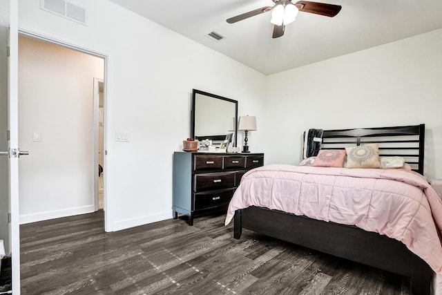 bedroom with dark wood-style floors, baseboards, and a ceiling fan