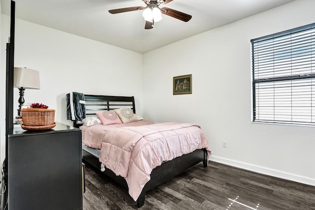 bedroom featuring dark wood-style floors, baseboards, and a ceiling fan
