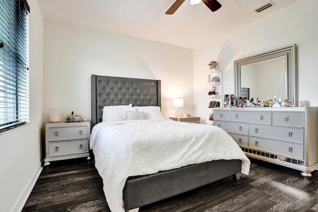 bedroom with dark wood-style floors, a ceiling fan, and baseboards