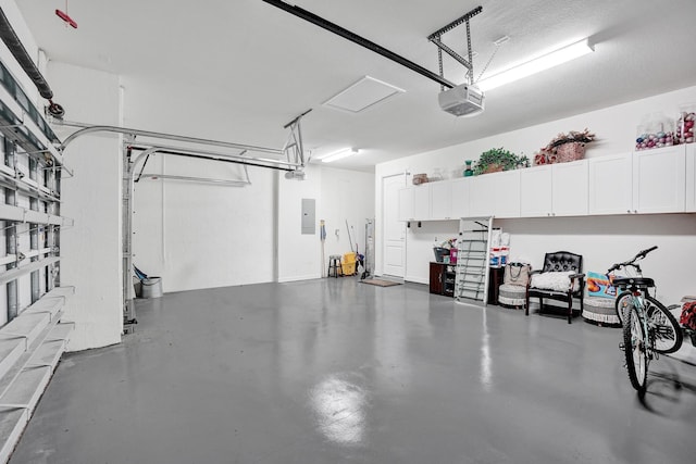 garage with electric panel and a garage door opener