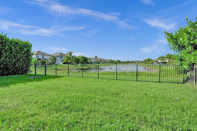 view of yard featuring a water view and a residential view
