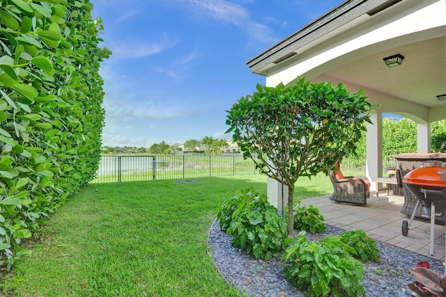 view of yard with a patio and a water view