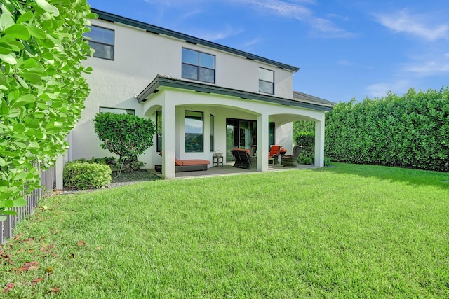 back of house featuring stucco siding, a patio area, and outdoor lounge area