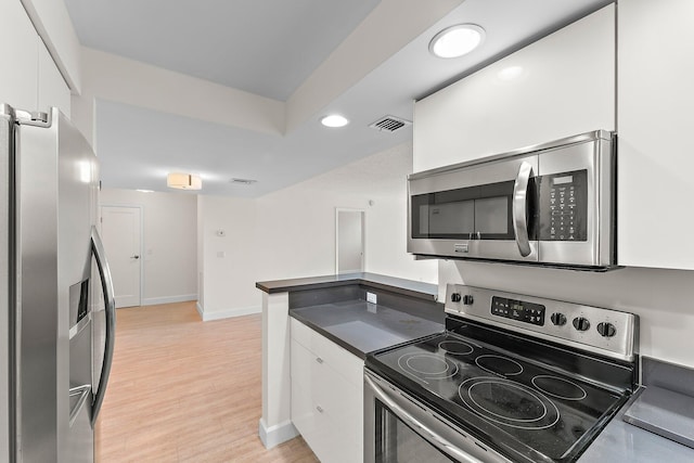 kitchen featuring stainless steel appliances, white cabinets, baseboards, recessed lighting, and light wood-style flooring