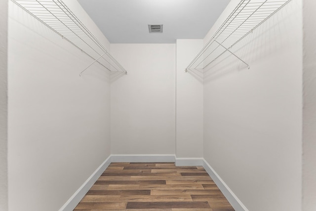 spacious closet with wood finished floors