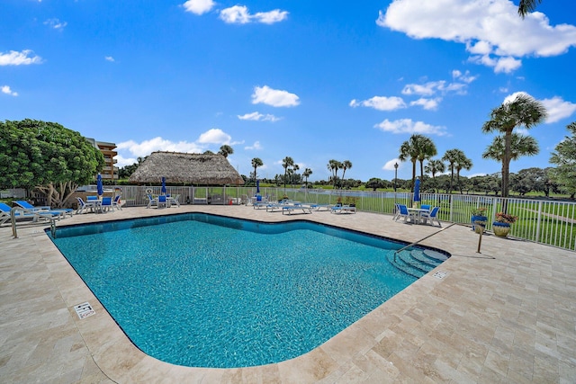 community pool featuring a patio and fence