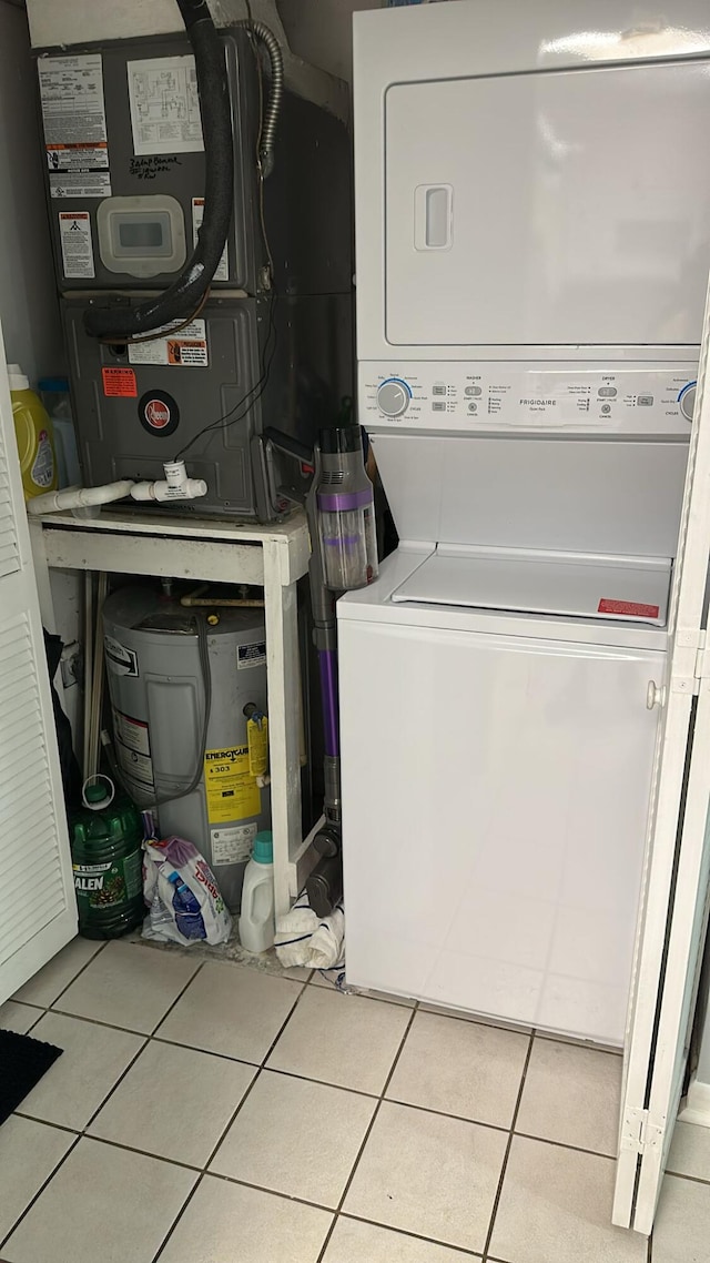 4155 NW 90th Ave Unit 106, Coral Springs, FL 33065 - laundry room featuring stacked washer / dryer, tile patterned floors, and heating unit