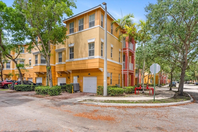 3518 Shoma Dr, Royal Palm Beach, FL 33414 - view of property with an attached garage and central AC