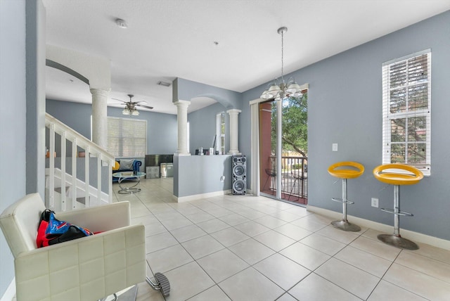 3518 Shoma Dr, Royal Palm Beach, FL 33414 - tiled dining room featuring ornate columns, baseboards, and arched walkways