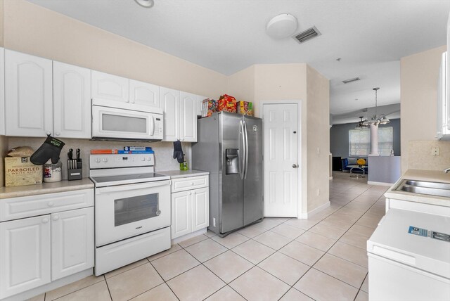 3518 Shoma Dr, Royal Palm Beach, FL 33414 - kitchen featuring white appliances, a sink, white cabinets, light tile patterned floors, and light countertops