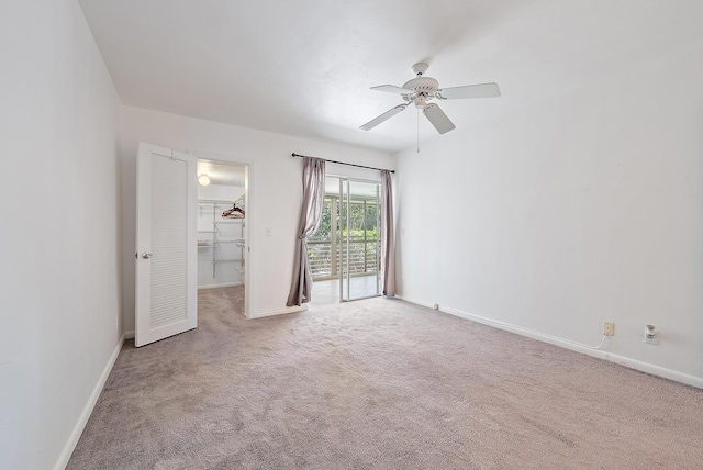 carpeted empty room with baseboards and ceiling fan