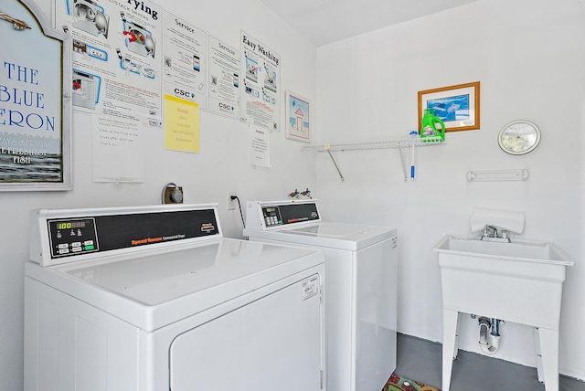 washroom featuring washing machine and clothes dryer and a sink
