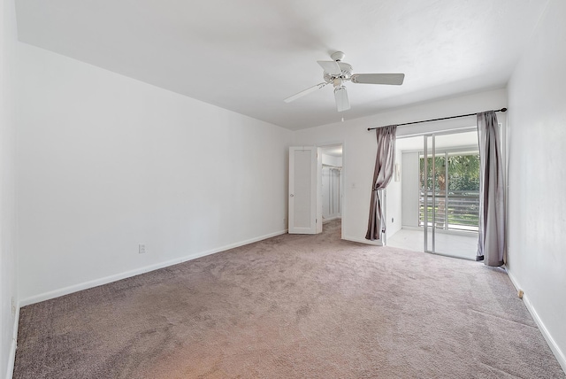spare room with carpet flooring, a ceiling fan, and baseboards