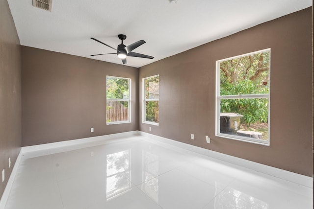 632 SW Mccall Rd, Port Saint Lucie, FL 34953 - tiled empty room with plenty of natural light, ceiling fan, and baseboards