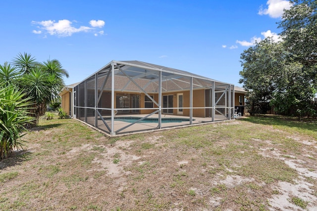 632 SW Mccall Rd, Port Saint Lucie, FL 34953 - back of property featuring an outdoor pool, a lanai, and a lawn
