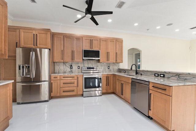 632 SW Mccall Rd, Port Saint Lucie, FL 34953 - kitchen featuring appliances with stainless steel finishes, a sink, arched walkways, ceiling fan, and backsplash