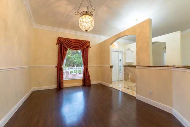 2853 SE Melaleuca Blvd, Port Saint Lucie, FL 34952 - empty room with arched walkways, a chandelier, wood finished floors, and crown molding