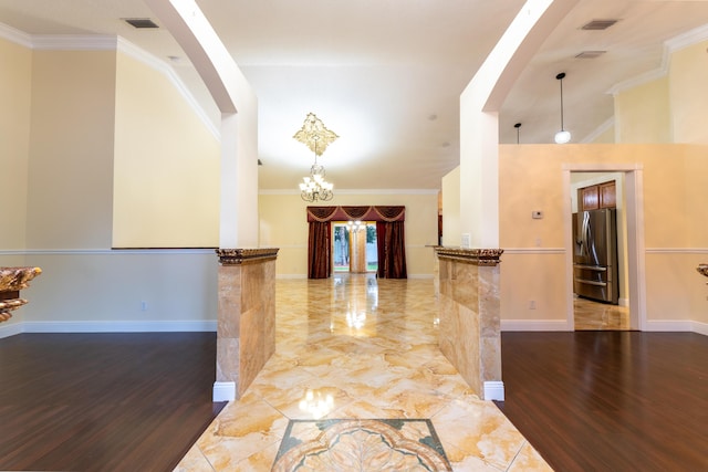 2853 SE Melaleuca Blvd, Port Saint Lucie, FL 34952 - hall with arched walkways, ornamental molding, wood finished floors, and a chandelier