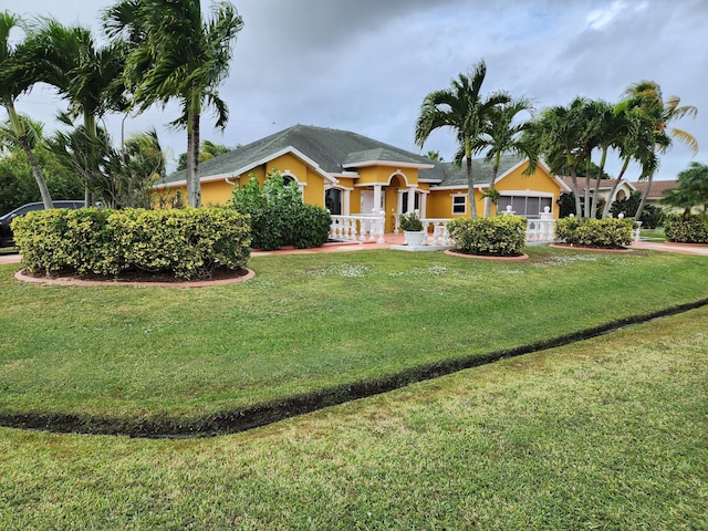 2853 SE Melaleuca Blvd, Port Saint Lucie, FL 34952 - ranch-style house with a garage, a front yard, and stucco siding