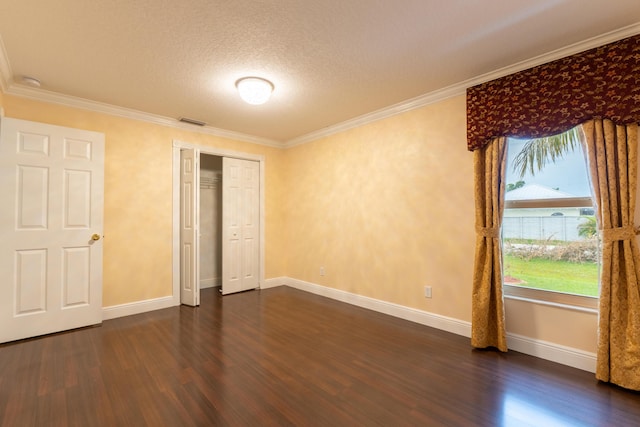 2853 SE Melaleuca Blvd, Port Saint Lucie, FL 34952 - unfurnished bedroom featuring dark wood-style flooring, crown molding, a textured ceiling, and a closet