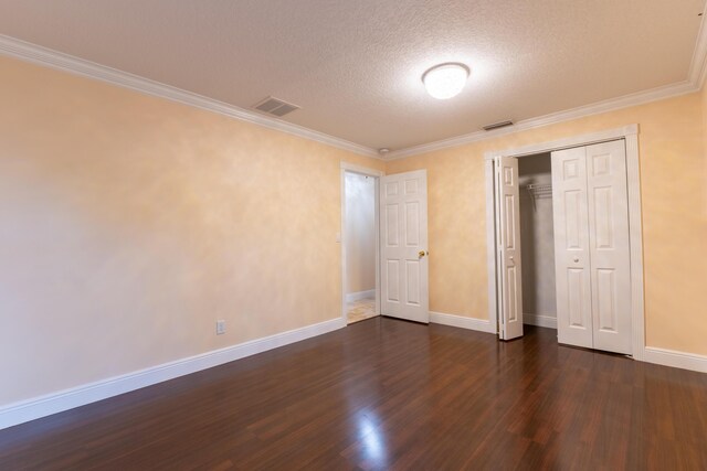 2853 SE Melaleuca Blvd, Port Saint Lucie, FL 34952 - unfurnished bedroom with dark wood-style floors, a textured ceiling, crown molding, and a closet