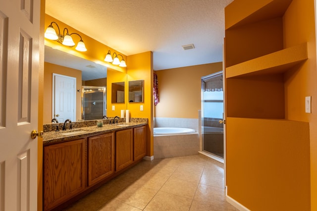 2853 SE Melaleuca Blvd, Port Saint Lucie, FL 34952 - bathroom featuring a stall shower, tile patterned flooring, a garden tub, double vanity, and a textured ceiling