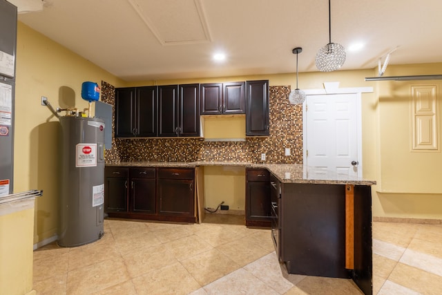 2853 SE Melaleuca Blvd, Port Saint Lucie, FL 34952 - kitchen with water heater, backsplash, hanging light fixtures, light stone counters, and recessed lighting