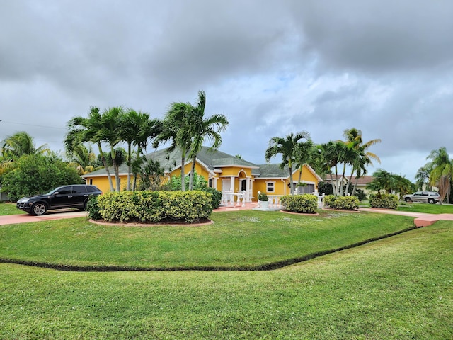 2853 SE Melaleuca Blvd, Port Saint Lucie, FL 34952 - view of front of house with stucco siding and a front yard