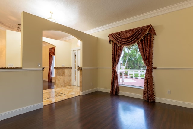 2853 SE Melaleuca Blvd, Port Saint Lucie, FL 34952 - empty room featuring arched walkways, wood finished floors, crown molding, and a textured ceiling
