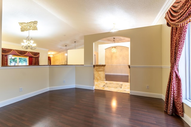 2853 SE Melaleuca Blvd, Port Saint Lucie, FL 34952 - spare room with wood finished floors, a chandelier, lofted ceiling, arched walkways, and ornamental molding
