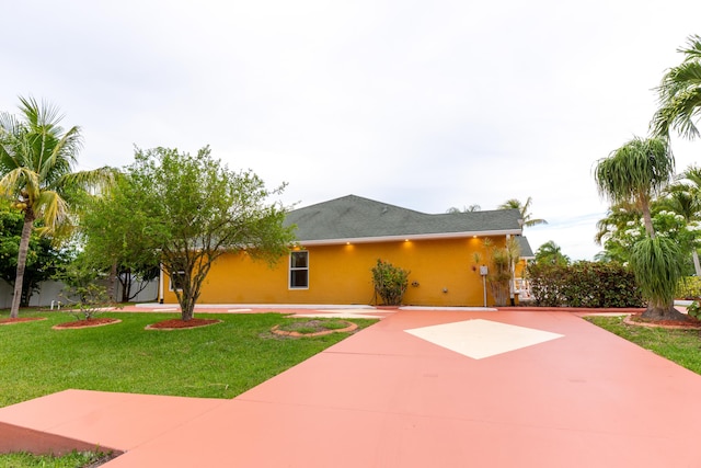 2853 SE Melaleuca Blvd, Port Saint Lucie, FL 34952 - view of front facade featuring stucco siding, a front yard, a patio, and driveway