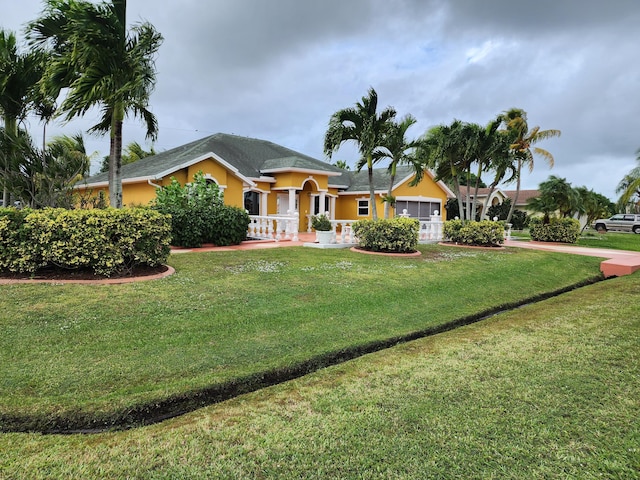 2853 SE Melaleuca Blvd, Port Saint Lucie, FL 34952 - view of front of property with a front lawn, an attached garage, stucco siding, and driveway