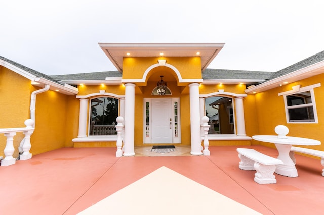 2853 SE Melaleuca Blvd, Port Saint Lucie, FL 34952 - view of exterior entry featuring roof with shingles and stucco siding