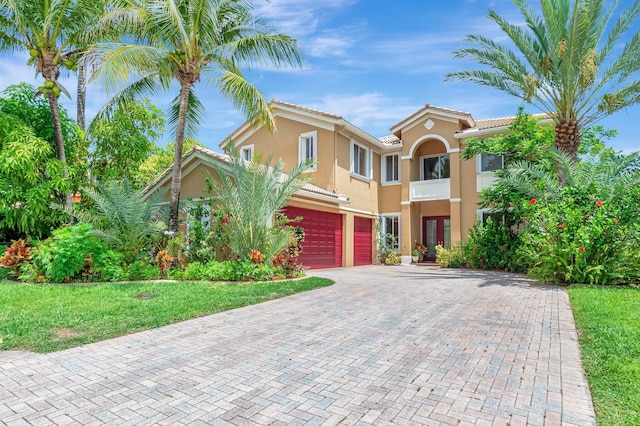 116 Ibisca Ter, Royal Palm Beach, FL 33411 - mediterranean / spanish-style home with stucco siding, an attached garage, french doors, decorative driveway, and a tiled roof
