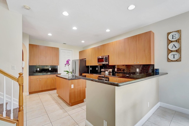 116 Ibisca Ter, Royal Palm Beach, FL 33411 - kitchen with appliances with stainless steel finishes, light tile patterned floors, a center island, tasteful backsplash, and recessed lighting