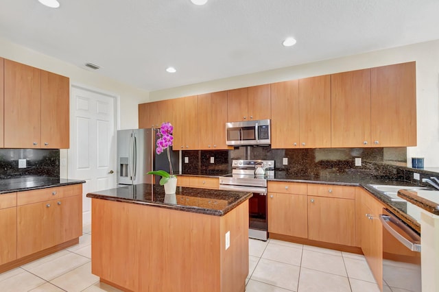 116 Ibisca Ter, Royal Palm Beach, FL 33411 - kitchen with stainless steel appliances, dark stone countertops, a sink, light tile patterned flooring, and recessed lighting