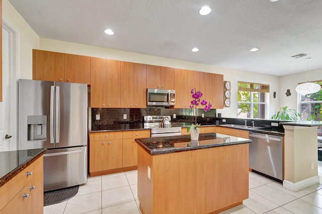 116 Ibisca Ter, Royal Palm Beach, FL 33411 - kitchen featuring stainless steel appliances, a peninsula, light tile patterned flooring, a kitchen island, and recessed lighting