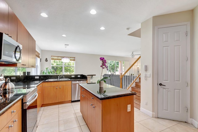 116 Ibisca Ter, Royal Palm Beach, FL 33411 - kitchen with stainless steel appliances, a sink, plenty of natural light, recessed lighting, and a kitchen island