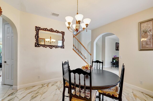 116 Ibisca Ter, Royal Palm Beach, FL 33411 - dining room with arched walkways, a chandelier, and light marble finish floors