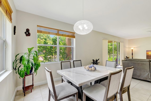 116 Ibisca Ter, Royal Palm Beach, FL 33411 - dining room featuring light tile patterned floors, a chandelier, and baseboards