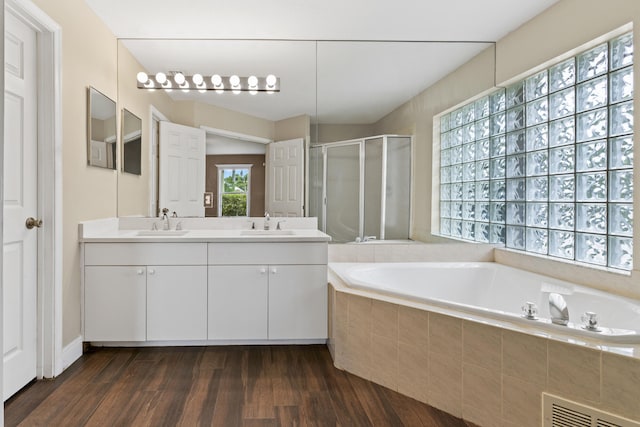 6342 120th Ave N, The Acreage, FL 33412 - bathroom featuring a shower stall, wood finished floors, a bath, and double vanity