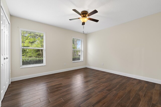 6342 120th Ave N, The Acreage, FL 33412 - unfurnished room featuring baseboards, dark wood finished floors, and a ceiling fan