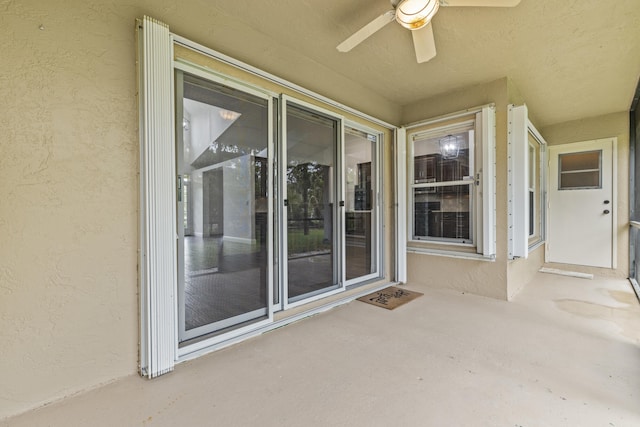 6342 120th Ave N, The Acreage, FL 33412 - doorway to property featuring a ceiling fan, stucco siding, and a patio area