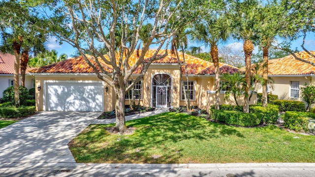 2211 Vero Beach Ln, West Palm Beach, FL 33411 - mediterranean / spanish house with stucco siding, an attached garage, a tiled roof, a front lawn, and concrete driveway