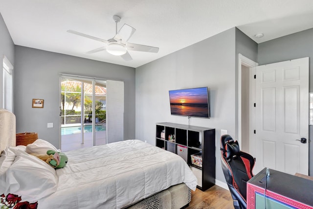 2211 Vero Beach Ln, West Palm Beach, FL 33411 - bedroom featuring access to exterior, wood finished floors, a ceiling fan, and baseboards