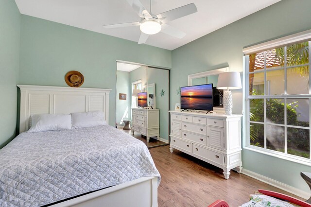 2211 Vero Beach Ln, West Palm Beach, FL 33411 - bedroom with multiple windows, dark wood-type flooring, baseboards, and a closet